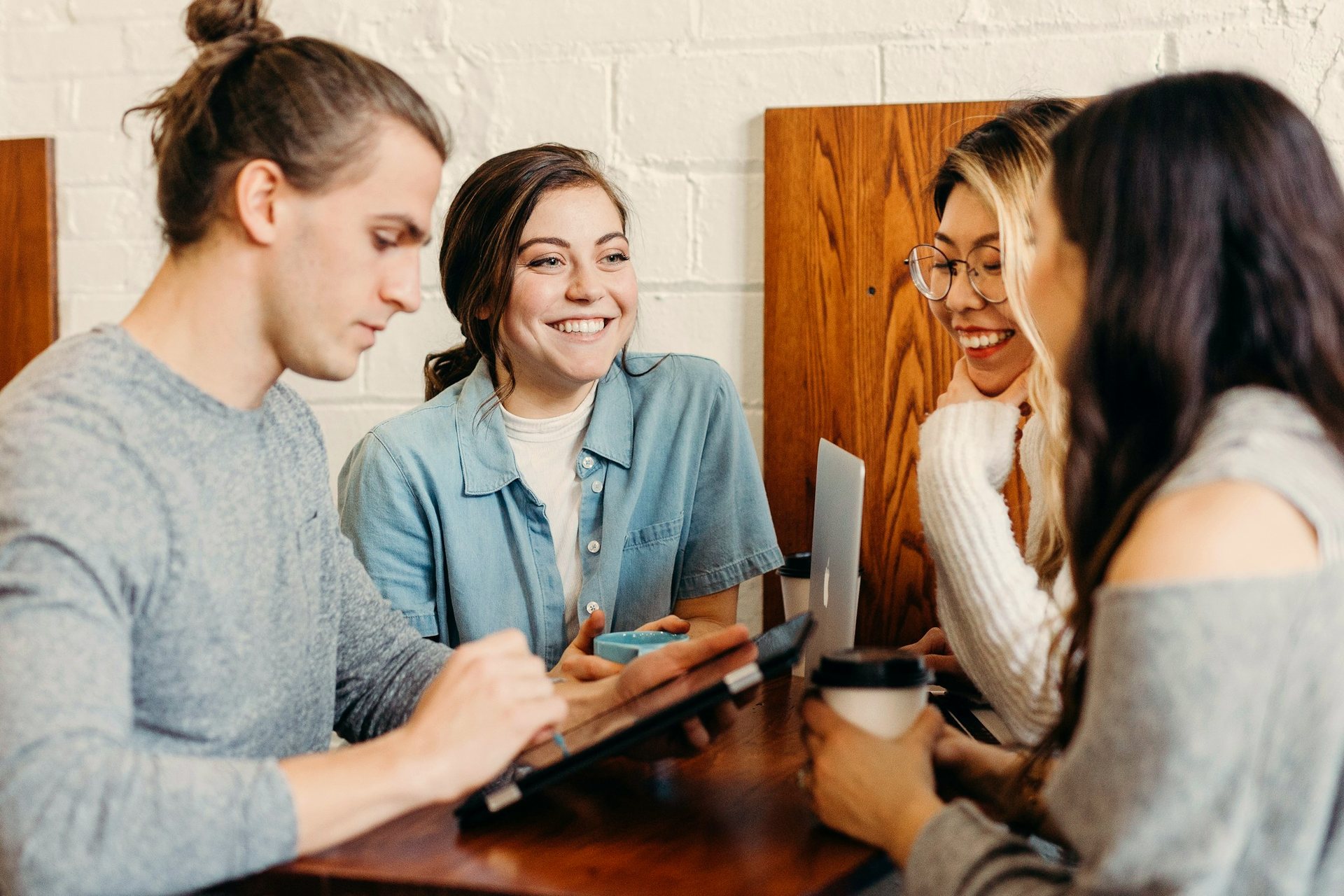 A worldwide team gathered around a tablet, collaborating over the network