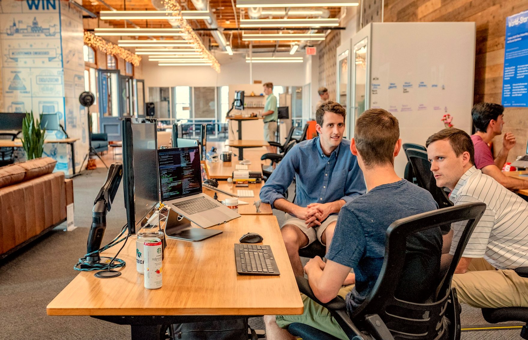 Engineers collaborating at sunlit desks in an open studio